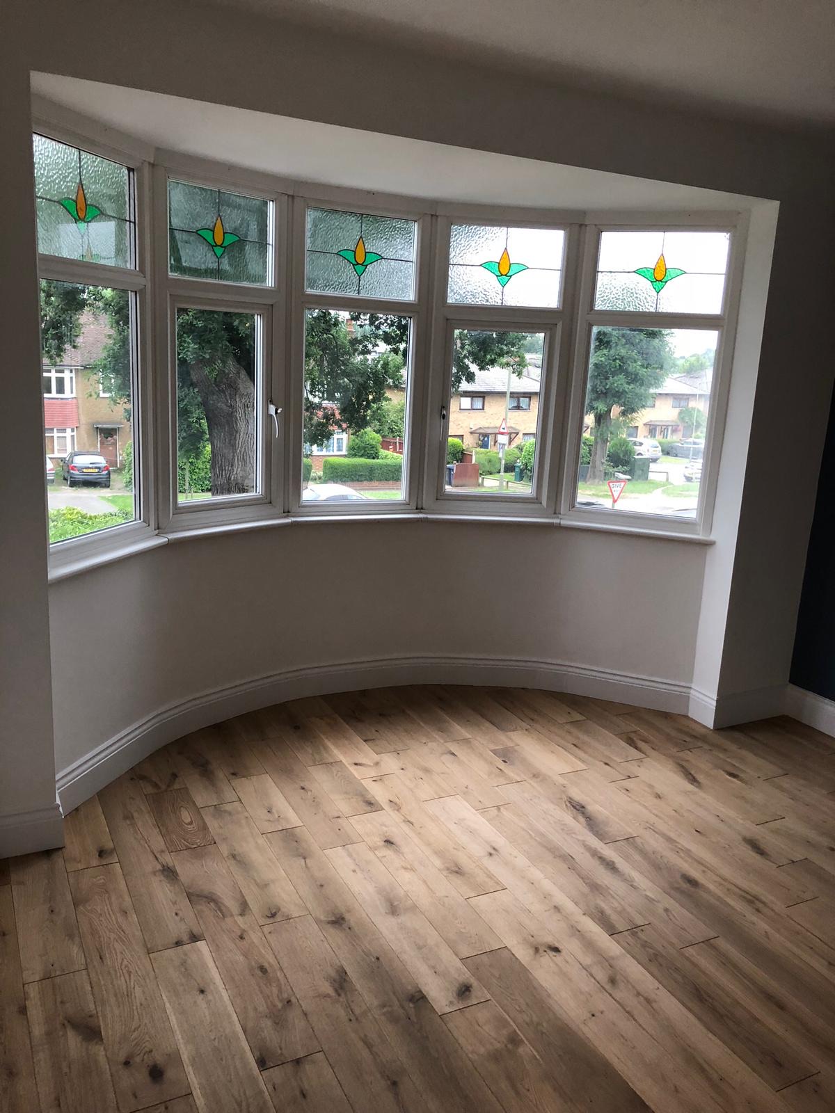 Bay window with stained glass and oak flooring