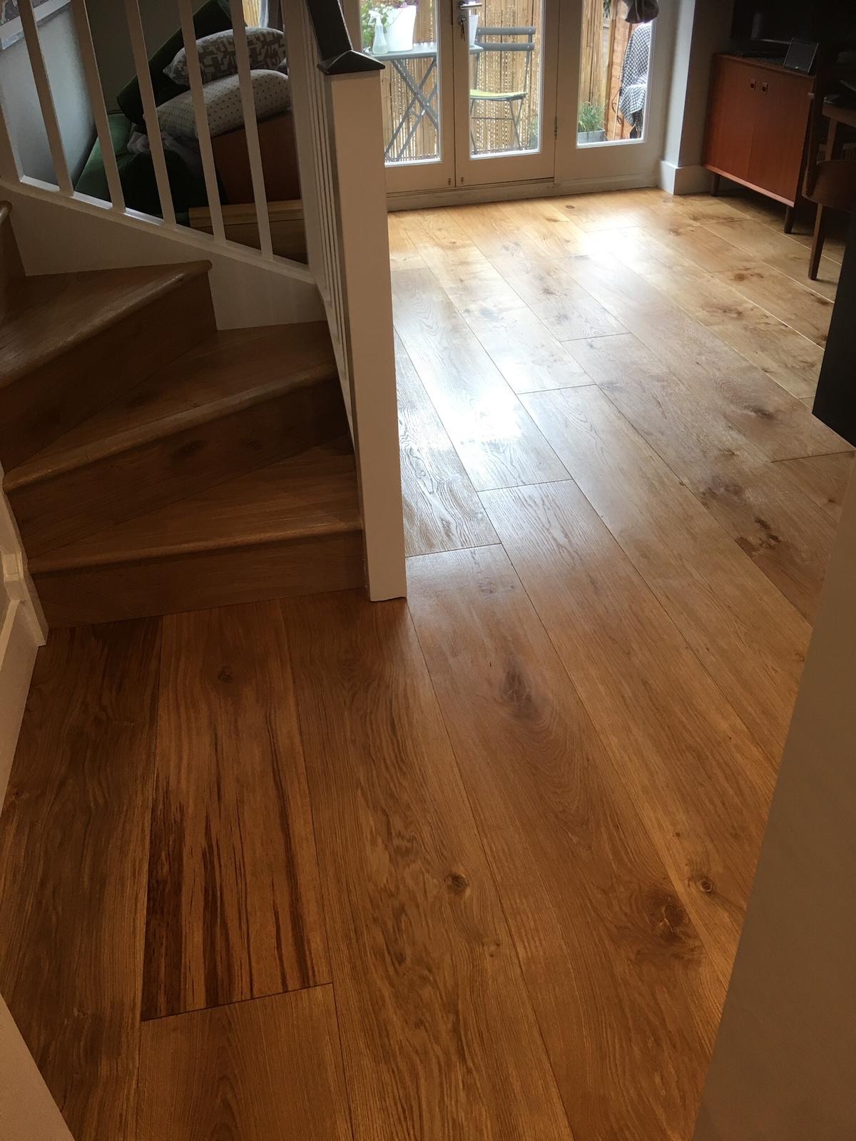 Oak flooring and staircase with French doors